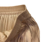 LIQUID LIGHT AND SOFT PLEATS: THE TIMELESS GOLDEN FLARE