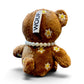 WOUF Choco Bear ベアバッグチャームの背面、デイジー刺繍とWOUFタグ、パール調ネックレスとしっぽ
